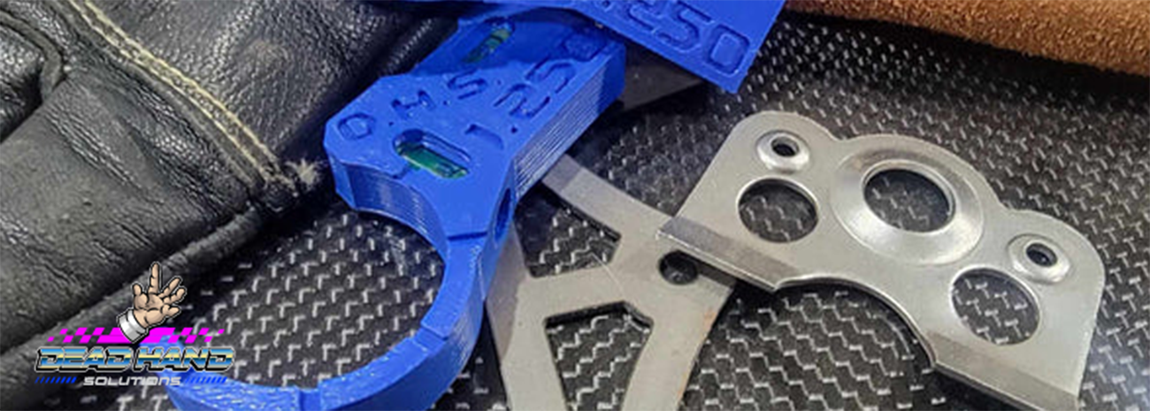 Image shows DeadHand jigs and fabrication tabs lying on a work surface