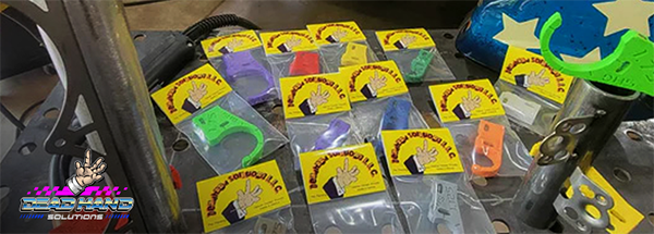Different size jigs in plastic packaging splayed out on table