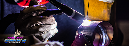 Person with gloves and protective gear TIG welding