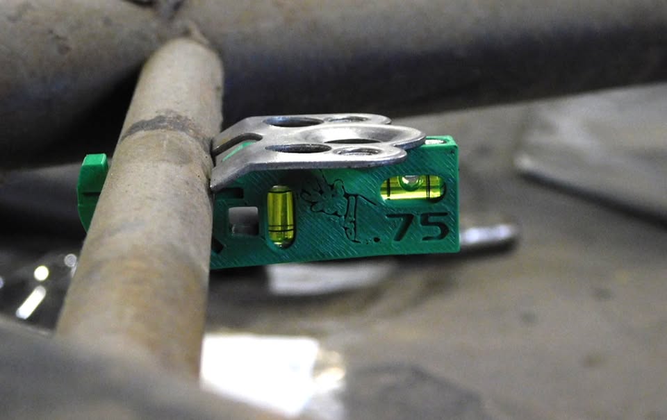 Dead Hand Solutions Chassis Speed Jig clipped onto small-diameter tubing holding a Dzus tab flush, demonstrating use on sprint car chassis fabrication